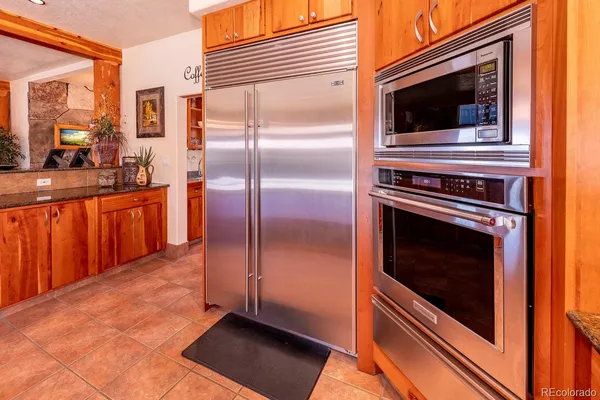 a large living room with stainless steel appliances granite countertop a large window