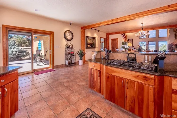 a living room with furniture a chandelier and a dining table