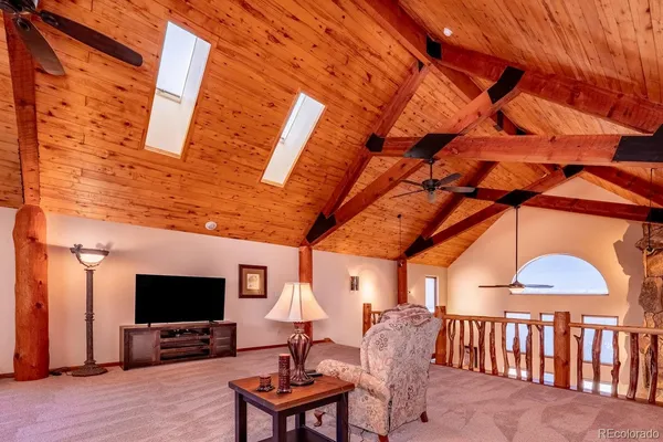 a living room with furniture a piano and wooden floor