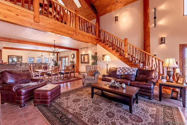 a living room with lots of furniture and a rug