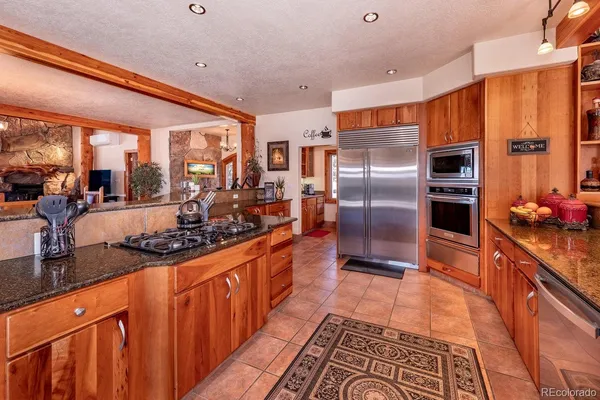 a living room with lots of furniture and kitchen view