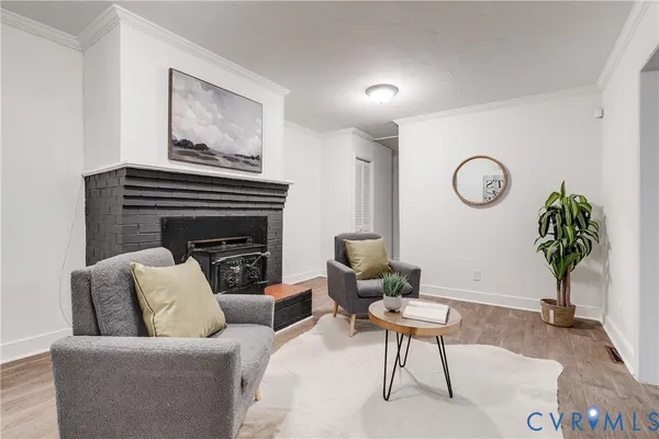 a living room with furniture a table and a potted plant