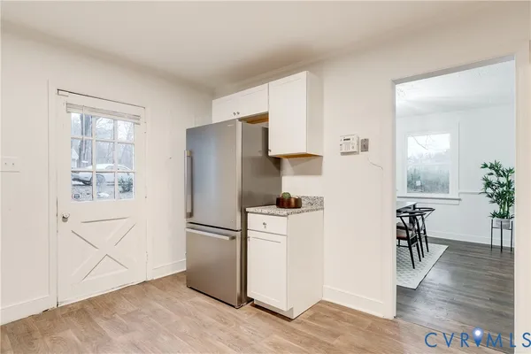a kitchen with stainless steel appliances a refrigerator and a stove top oven
