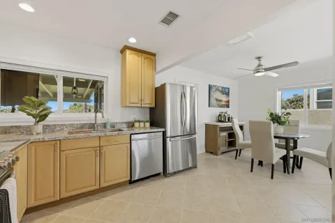 a kitchen with stainless steel appliances granite countertop a refrigerator and a sink