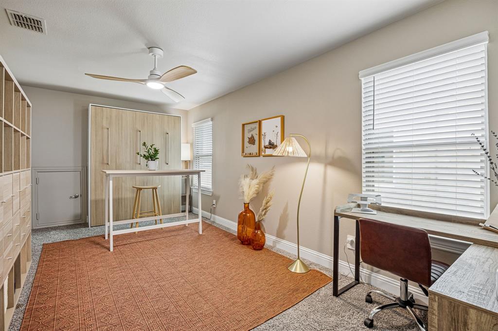 425 Breeds Hl Road Little Elm, TX 75068 - Photo 21 of 38 a bed room with a bed and a chair
