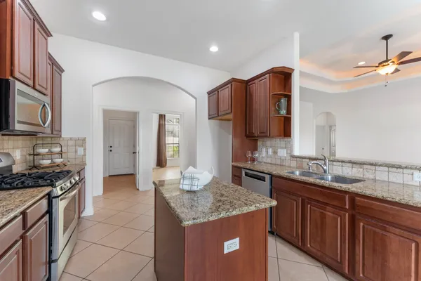 a kitchen with a stove sink and microwave
