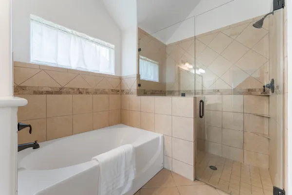 a bathroom with a bathtub and shower