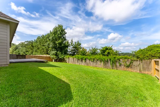 a view of a garden with a house in the background