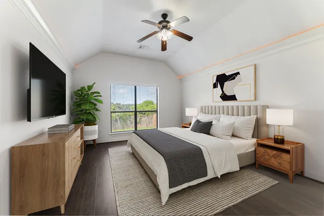 a bedroom with a large bed a flat tv screen and a chandelier