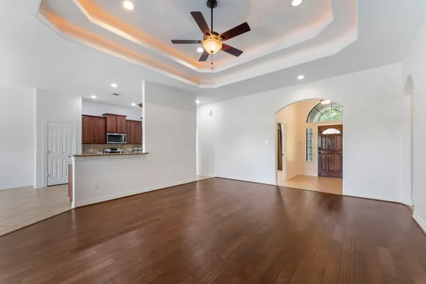 a kitchen with kitchen island granite countertop a sink and cabinets