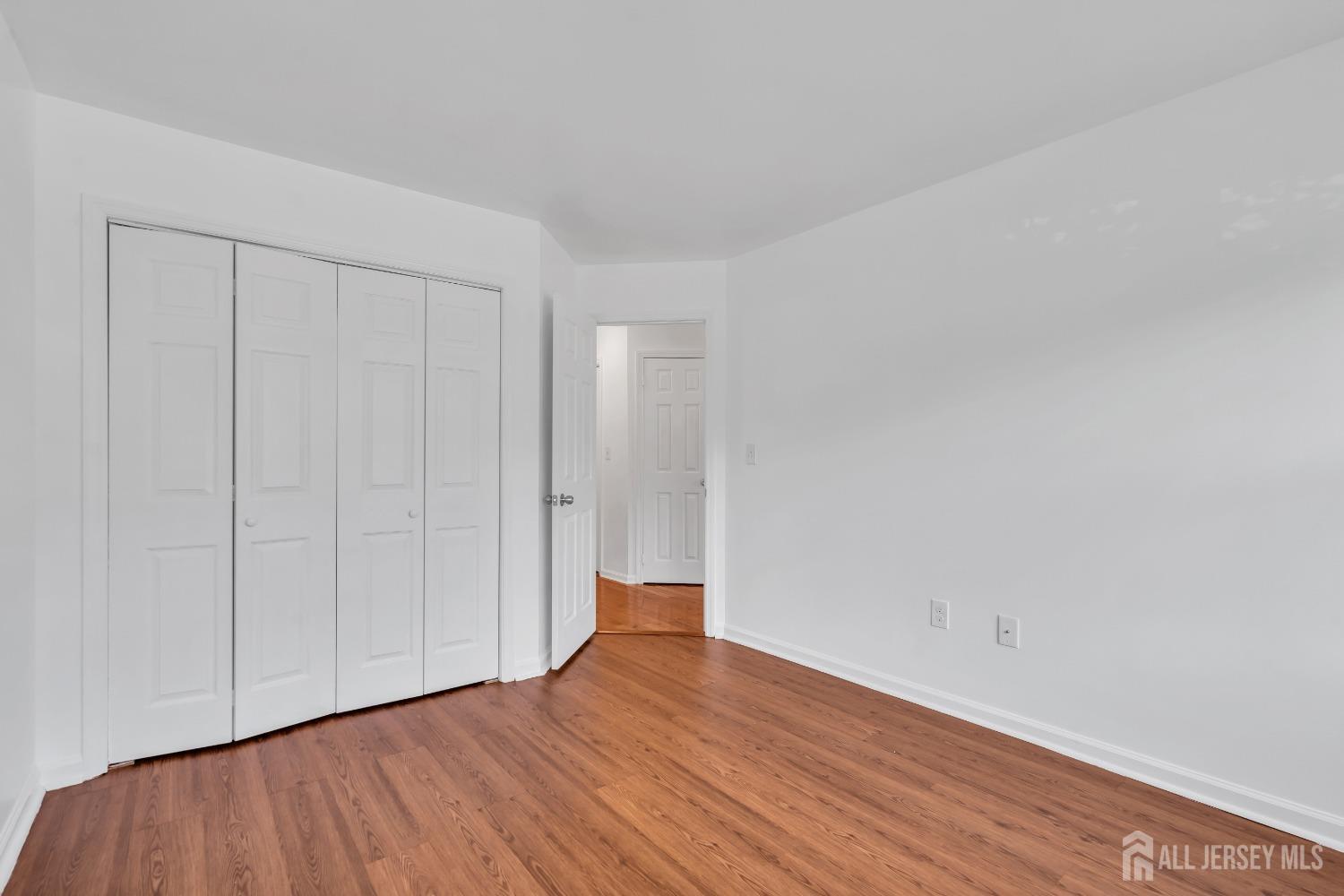 812 Edpas Road New Brunswick, NJ 08901 - Photo 18 of 31 a view of an empty room with wooden floor