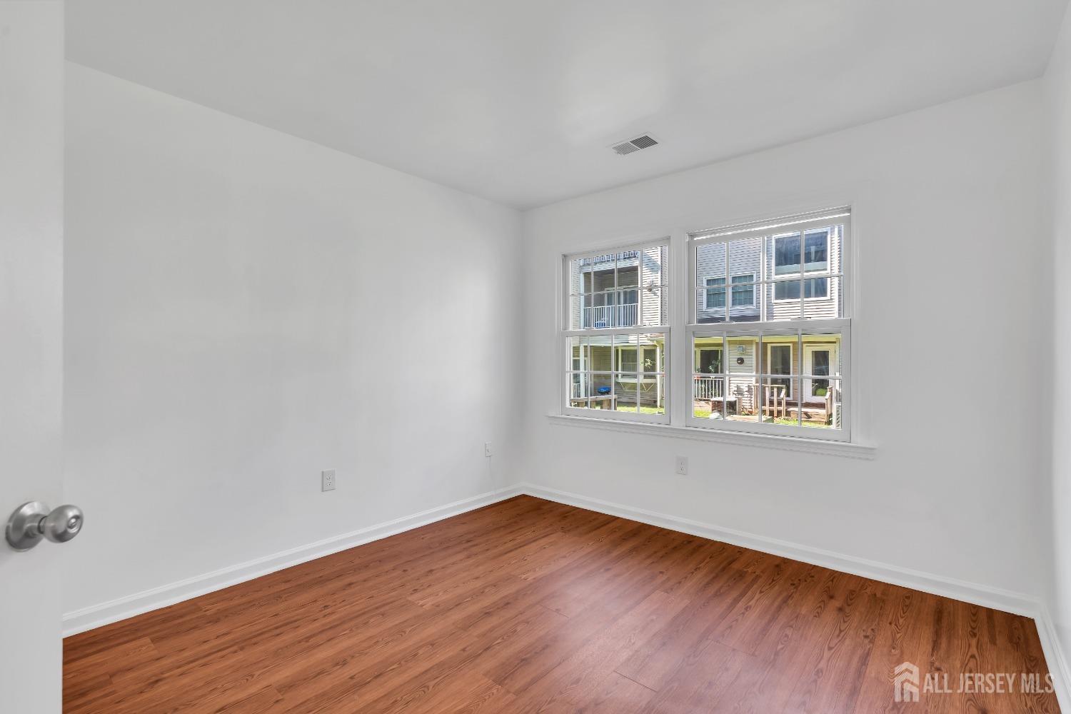 812 Edpas Road New Brunswick, NJ 08901 - Photo 21 of 31 a view of an empty room with wooden floor and windows