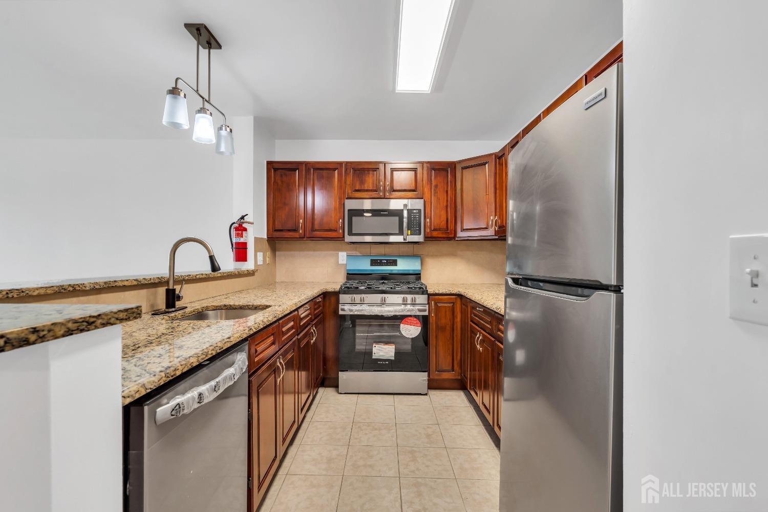 812 Edpas Road New Brunswick, NJ 08901 - Photo 3 of 31 a kitchen with stainless steel appliances granite countertop a sink stove and refrigerator