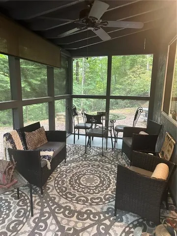 a living room with furniture and a floor to ceiling window