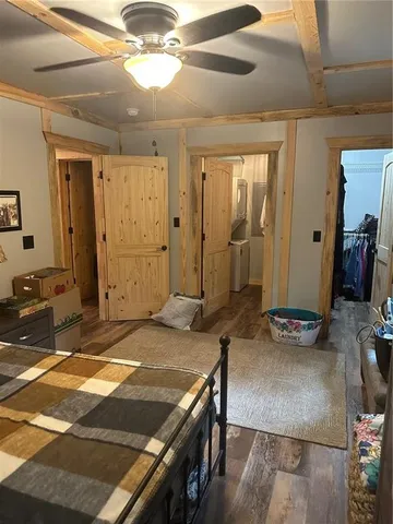 a bedroom with a bed and a chandelier