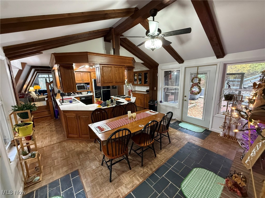 8116 Deer Road Southwest Bowerston, OH 44695 - Photo 14 of 49 Kitchen featuring brown cabinets, light countertops, a ceiling fan, a peninsula, and oven