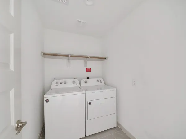 a spacious bedroom with a bed a couch and a flat screen tv