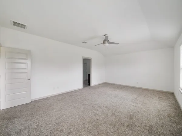 a view of an empty room with a sink and a window