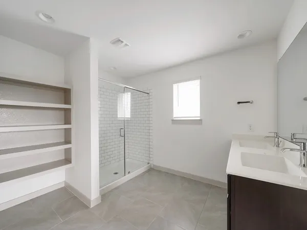 a bathroom with a sink a shower and a mirror