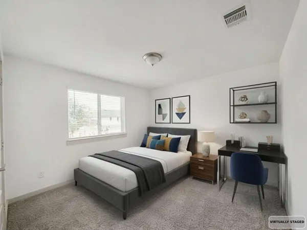 a bedroom with a bed and a workspace