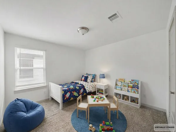 a bedroom with furniture and a large window