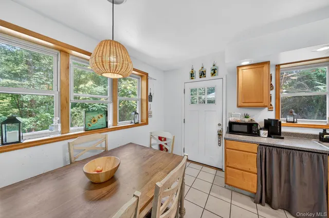 a kitchen with stainless steel appliances granite countertop a sink a stove and a wooden floors