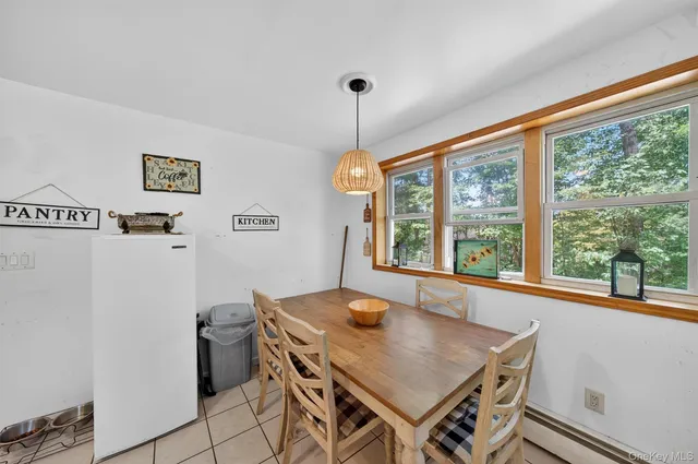a view of a dining room with furniture window and outside view