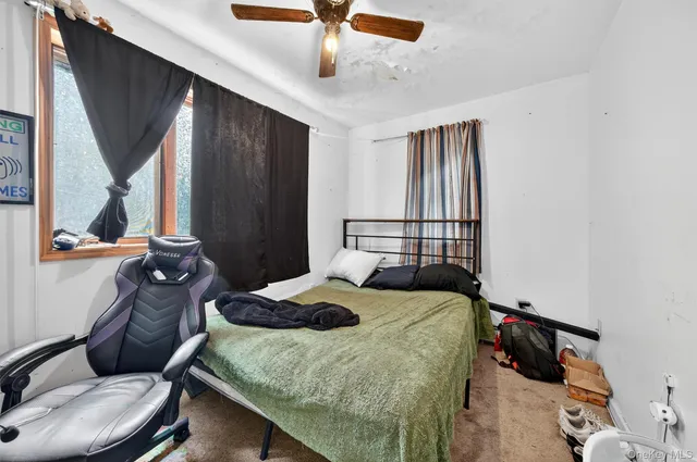 a bedroom with a bed and window