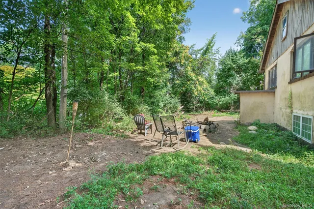 a view of yard with green space and seating area