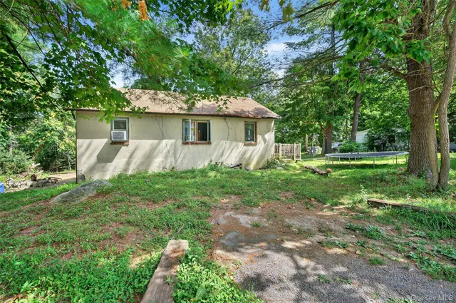 a view of a house with yard and a tree