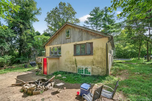 a view of backyard with deck and outdoor seating