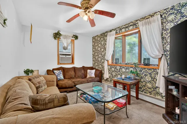 a living room with furniture a fireplace and a chandelier