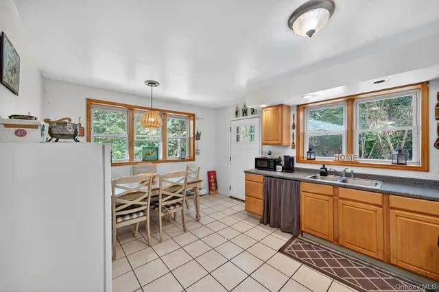a kitchen with stainless steel appliances granite countertop sink stove top oven and cabinets