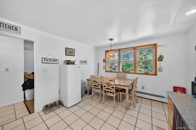 a dining room with furniture and a window