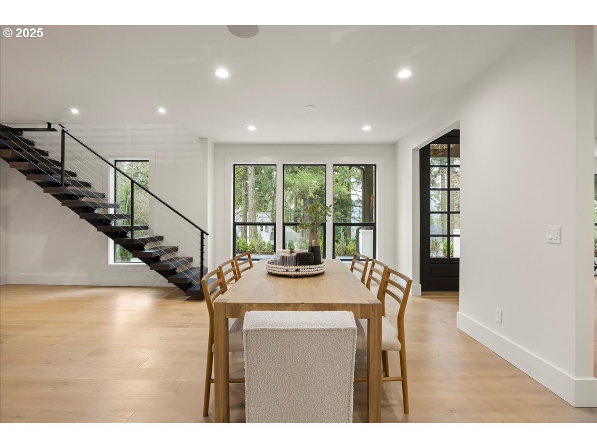 1572 Chandler Road Lake Oswego, OR 97034 - Photo 14 of 47 a view of a living room and kitchen with a floor to ceiling window