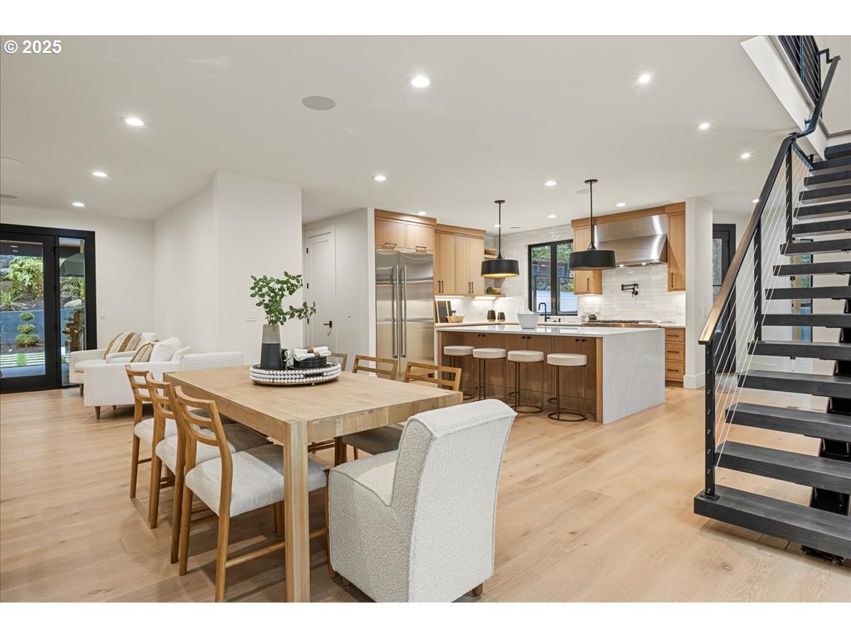 1572 Chandler Road Lake Oswego, OR 97034 - Photo 15 of 47 a kitchen with stainless steel appliances kitchen island granite countertop a table chairs and a refrigerator