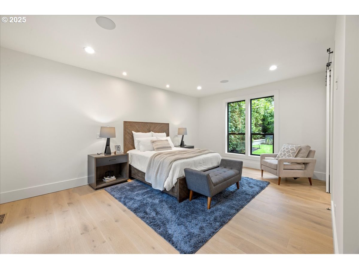 1572 Chandler Road Lake Oswego, OR 97034 - Photo 32 of 47 a spacious bedroom with a bed a table and large window