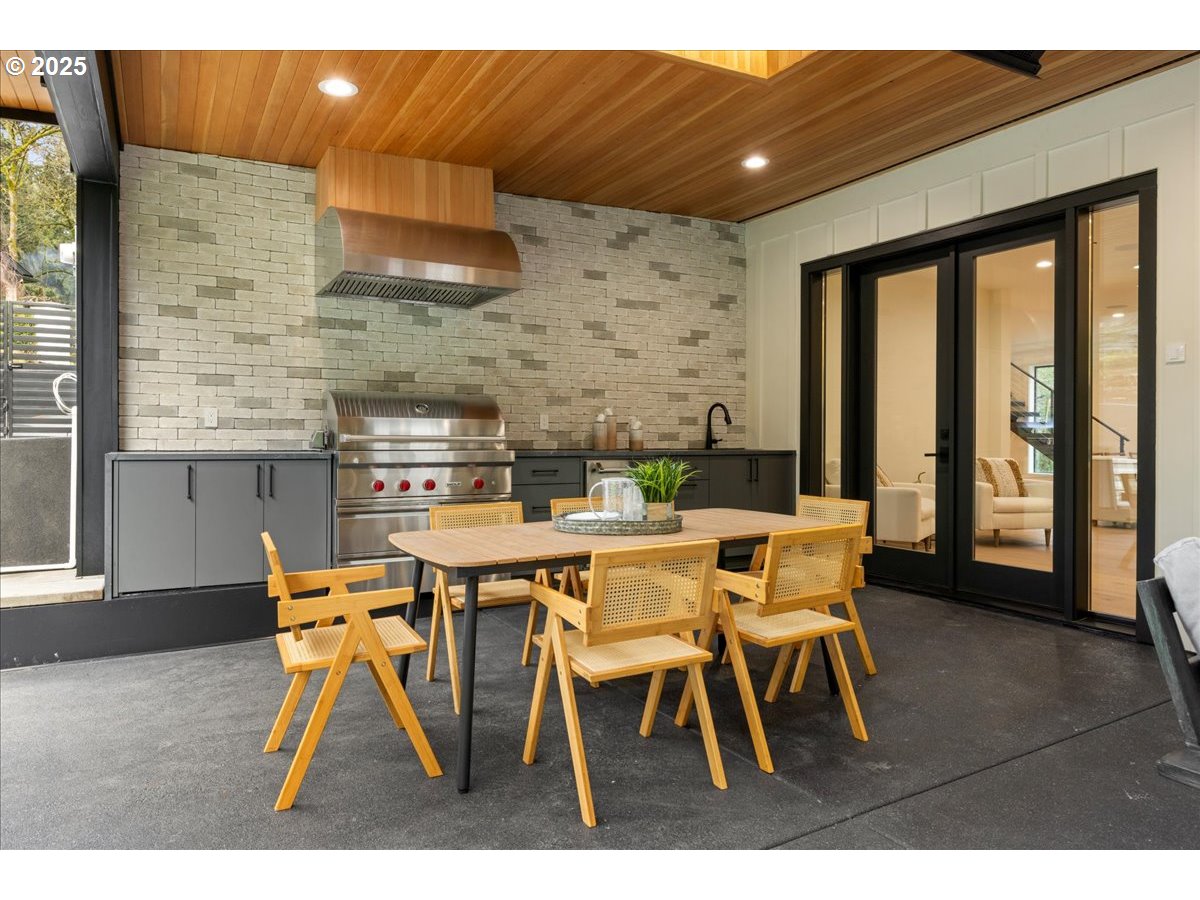 1572 Chandler Road Lake Oswego, OR 97034 - Photo 44 of 47 a dining room with stainless steel appliances kitchen island granite countertop a table and chairs