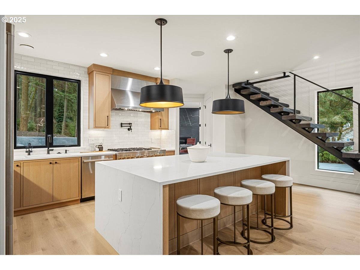 1572 Chandler Road Lake Oswego, OR 97034 - Photo 8 of 47 a kitchen with stainless steel appliances kitchen island granite countertop a sink a stove and a wooden floors
