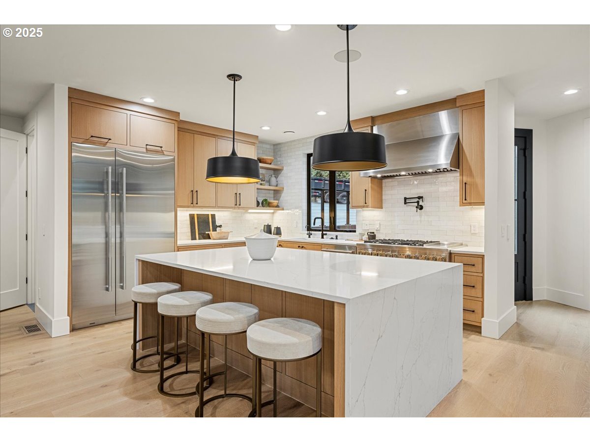 1572 Chandler Road Lake Oswego, OR 97034 - Photo 10 of 47 a kitchen with stainless steel appliances kitchen island granite countertop a sink and a refrigerator