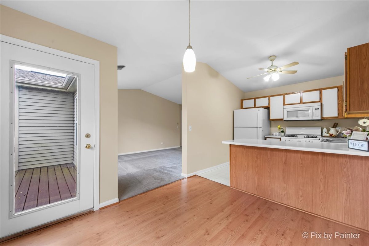 1023 Berkshire Court, Unit C Elgin, IL 60120 - Photo 11 of 54 a view of kitchen with granite countertop cabinets and wooden floor