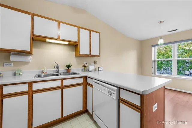 a kitchen with stainless steel appliances granite countertop a sink a stove and a refrigerator