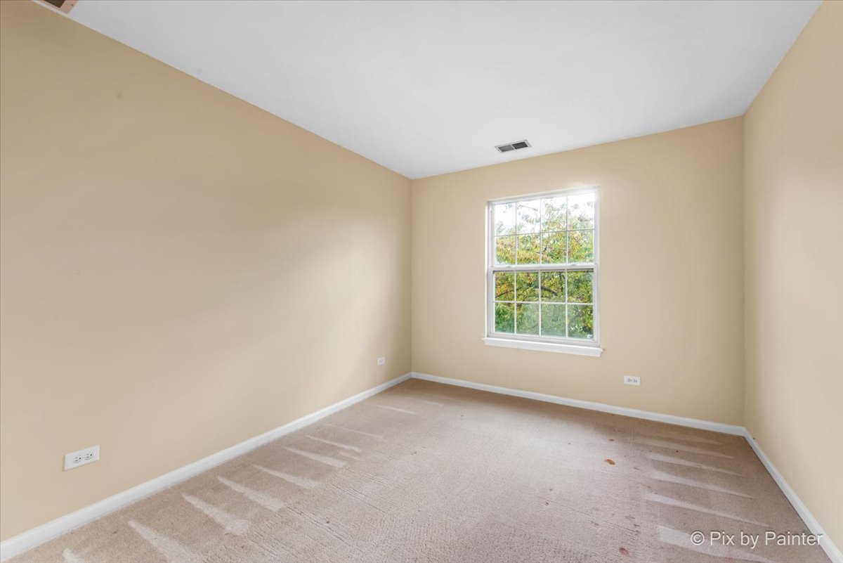 1023 Berkshire Court, Unit C Elgin, IL 60120 - Photo 22 of 54 an empty room with a window