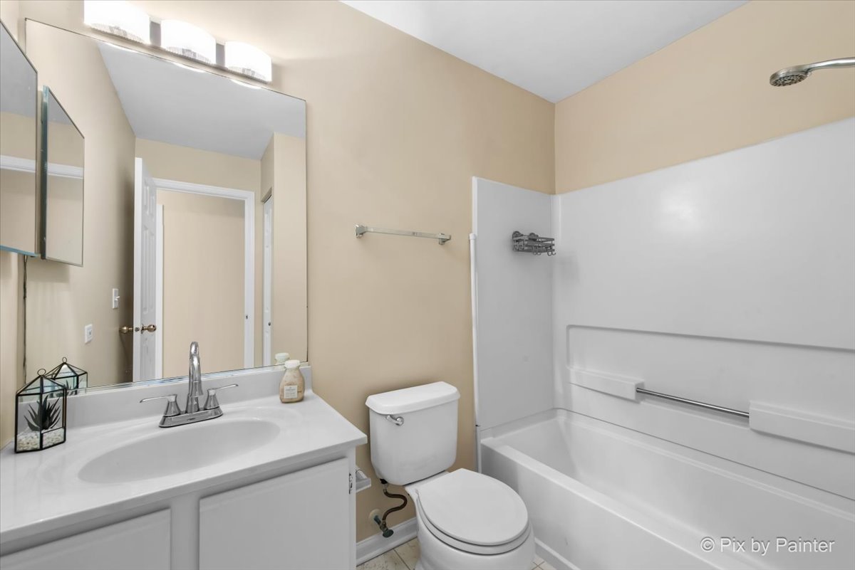 1023 Berkshire Court, Unit C Elgin, IL 60120 - Photo 25 of 54 a bathroom with a sink a toilet and shower