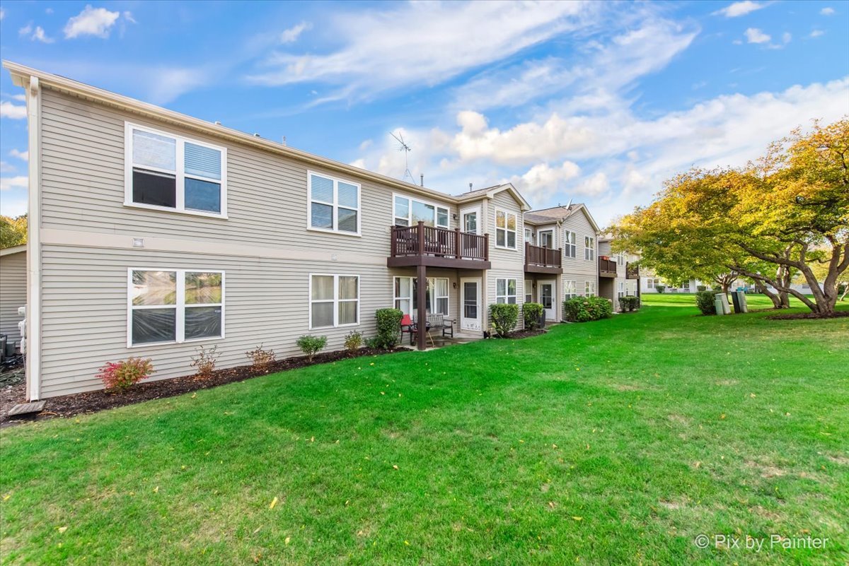 1023 Berkshire Court, Unit C Elgin, IL 60120 - Photo 30 of 54 a view of a house with a yard and garden