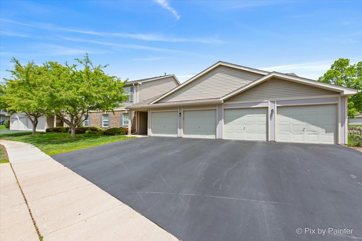 1023 Berkshire Court, Unit C Elgin, IL 60120 - Photo 3 of 54 a view of a house with a yard and large tree