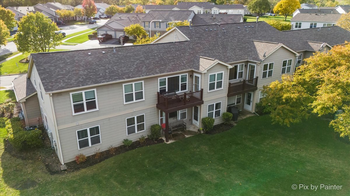 1023 Berkshire Court, Unit C Elgin, IL 60120 - Photo 38 of 54 a aerial view of a house with a yard and potted plants