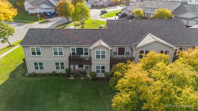 an aerial view of a house with a garden and swimming pool
