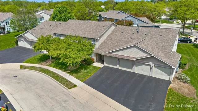 an aerial view of a house with a yard and a garage