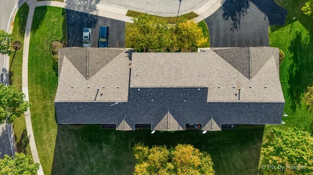 an aerial view of residential houses with outdoor space